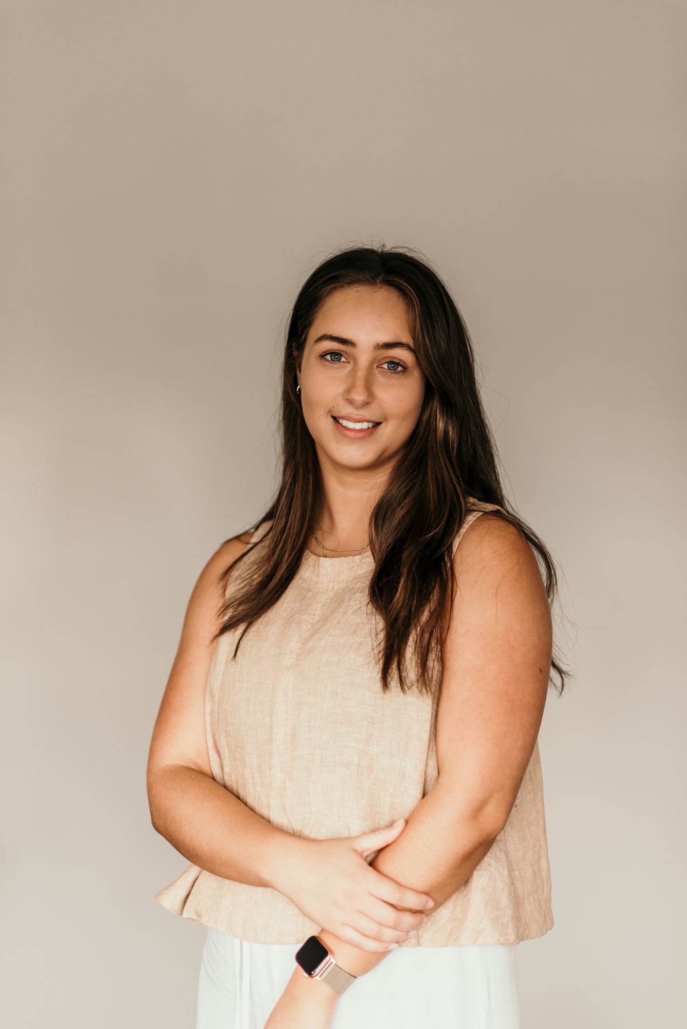 Professional indoor portrait against a neutral beige background in Christchurch.