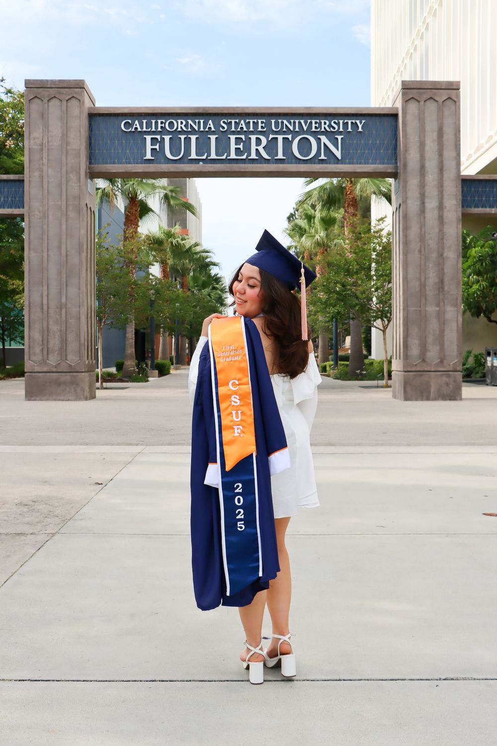 Graduation photos taken at California State University Fullerton campus entrance.