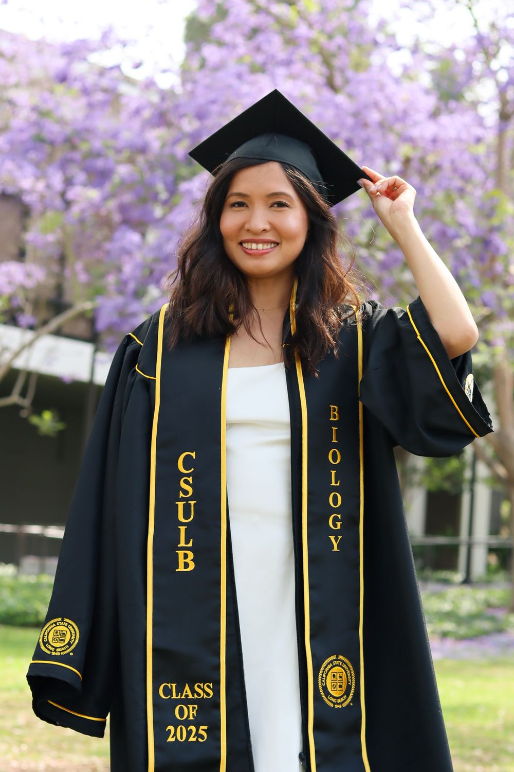 Graduate wearing decorated graduation stole and cap with Class of 2025 sash.