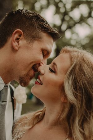 Close-up romantic moment between couple during golden hour wedding photoshoot.