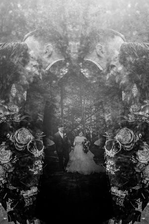 Artistic black and white double exposure wedding photo with floral overlay and forest background.