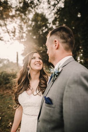 Candid wedding moment captured during golden hour in an outdoor setting.