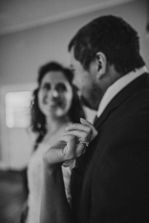An intimate black and white moment captured between newlyweds sharing a tender moment.