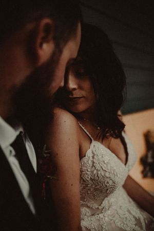 An intimate moment captured between a couple in warm moody lighting.