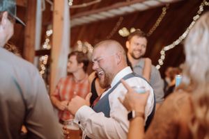 Wedding reception guests enjoying a celebration under string lights.