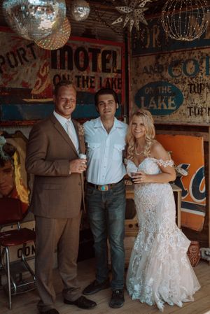 Wedding celebration at retro-themed venue with vintage motel signs and disco balls.