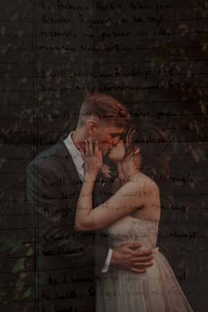 An intimate embrace against a dark wall with handwritten text overlay.