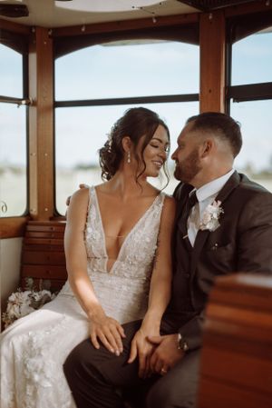 An intimate wedding portrait taken inside a vintage trolley or train car.