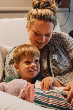 Intimate family moment on a hospital bed with a newborn.