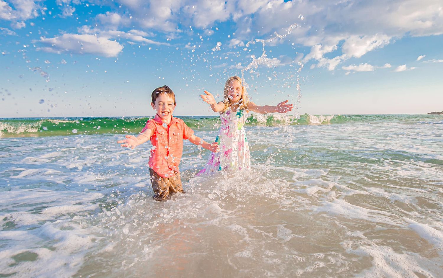 Orange Beach sibling playing in the waves Gulf splashing fun with family photo