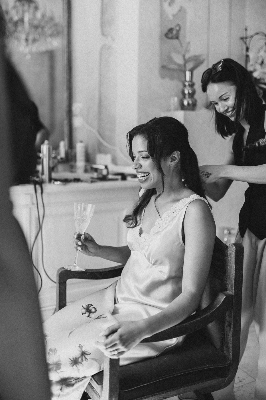 A candid black and white photo capturing preparations on the morning of a wedding day.
