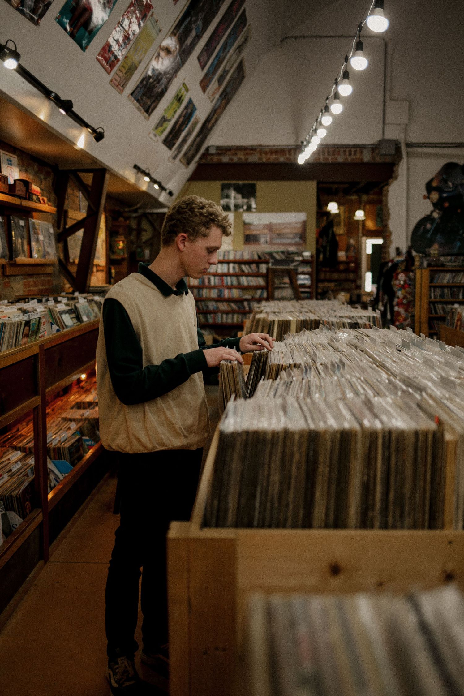 High school senior photo browsing a record store in Oklahoma City Oklahoma