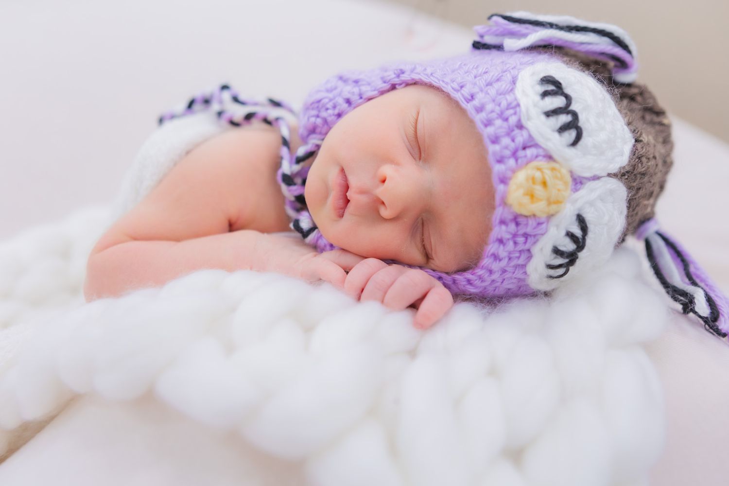 sleeping baby with homemade hat sleeping on a cloud. interesting and creative and simple newborn photography
