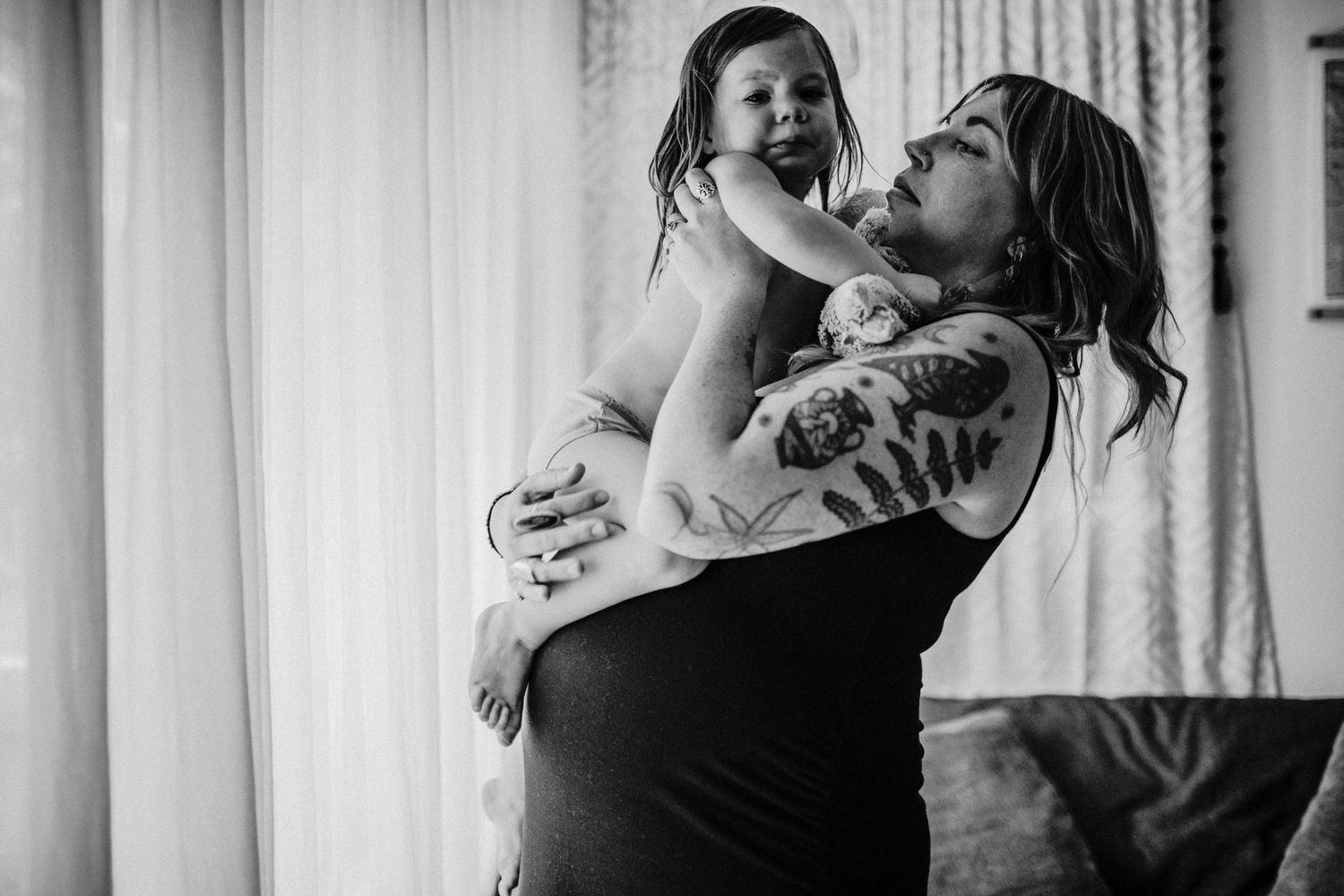 mother is holding crying child portland oregon family photographer rushes & waves