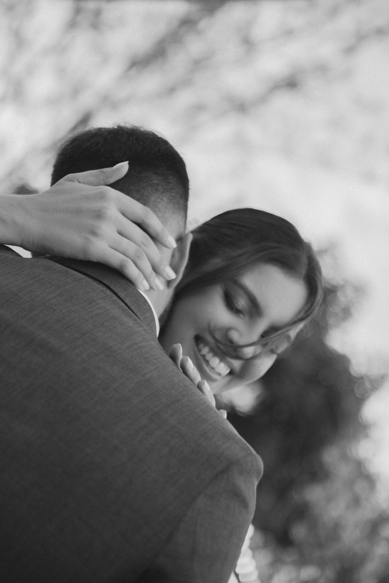 Black and white portrait of a romantic wedding embrace showing genuine emotion.