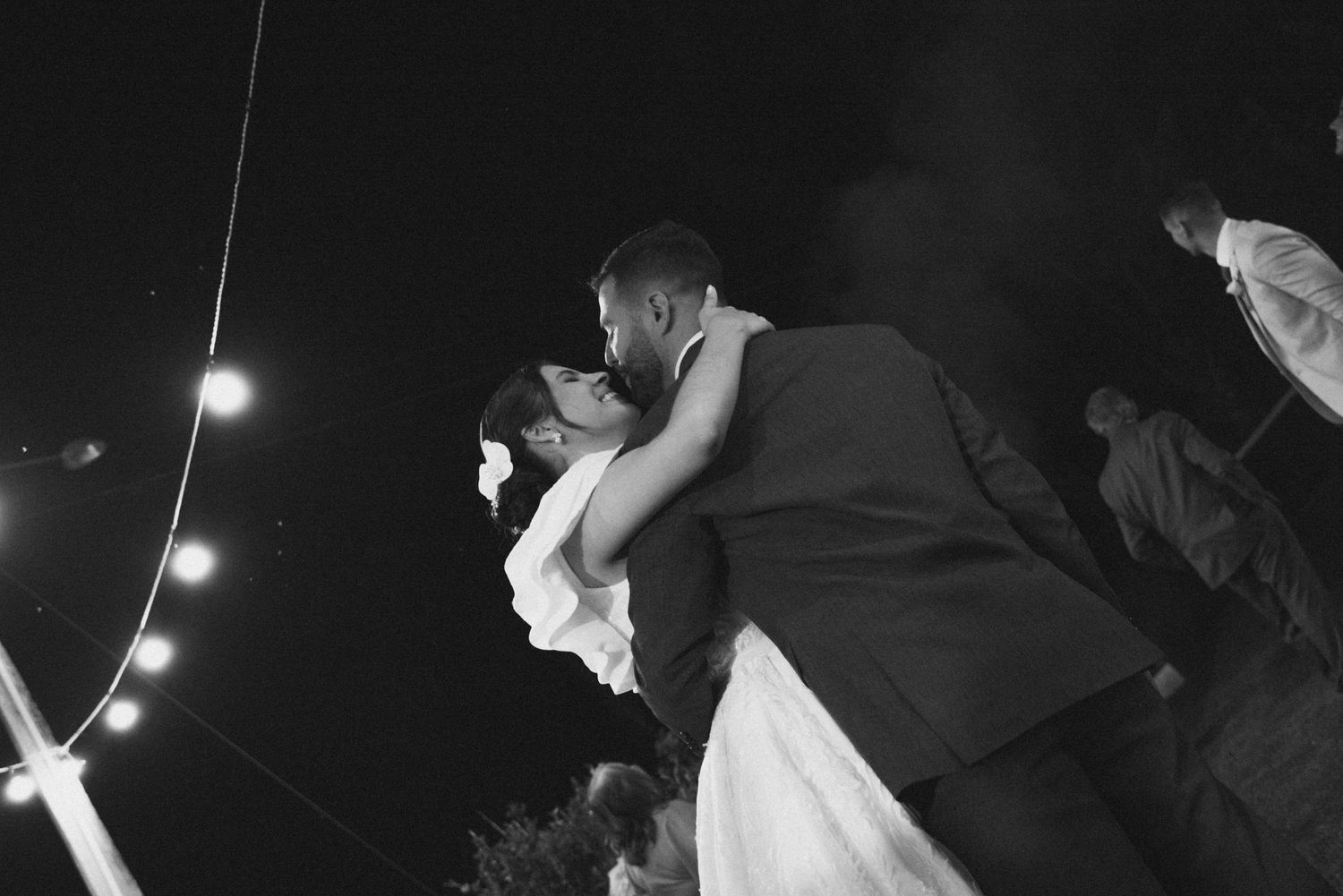 A dramatic dance lift between newlyweds at their evening reception.