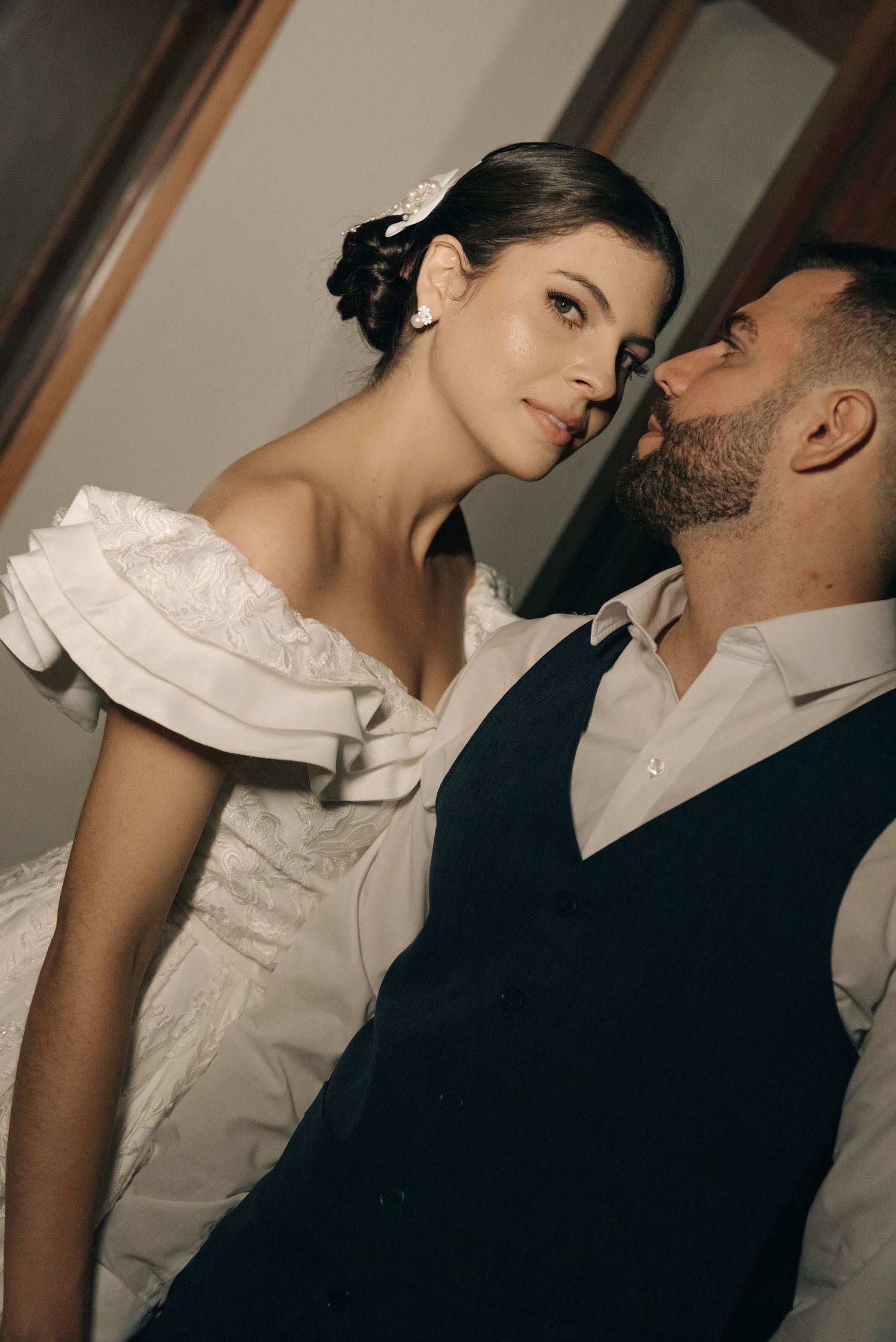 An intimate close-up portrait of newlyweds in formal wedding attire.