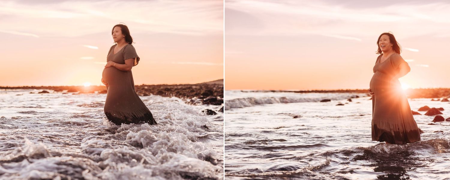 Woman in flowing dress standing in ocean waves during sunset photoshoot.