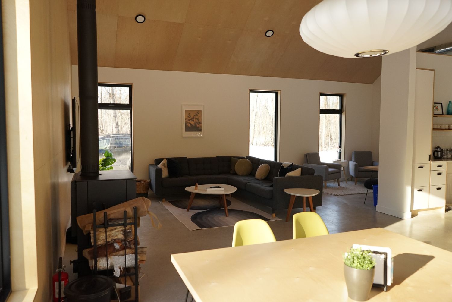 Modern living room interior with white walls, pendant lights, and contemporary furniture.