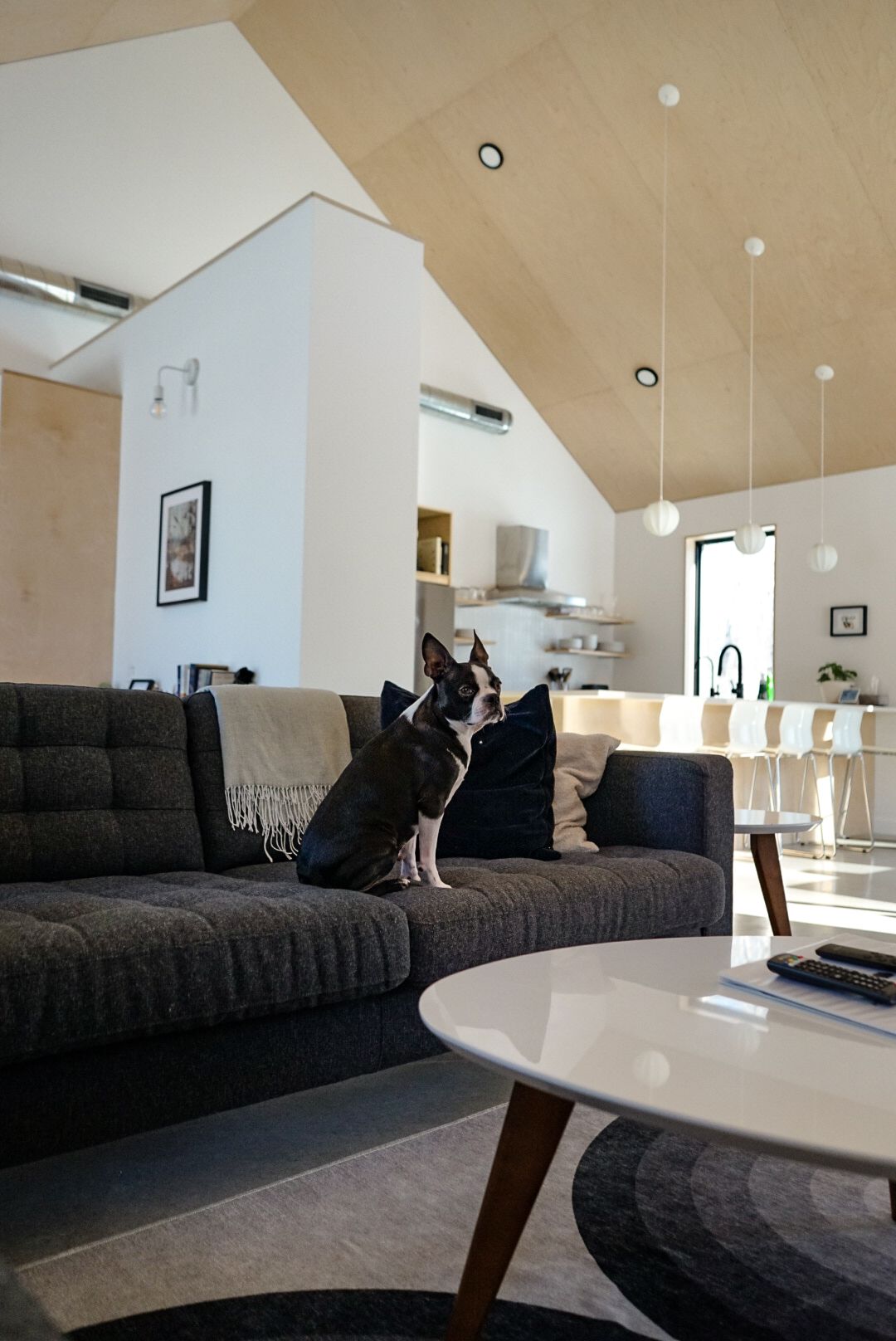 Contemporary living space with large black sectional sofa and modern coffee table.