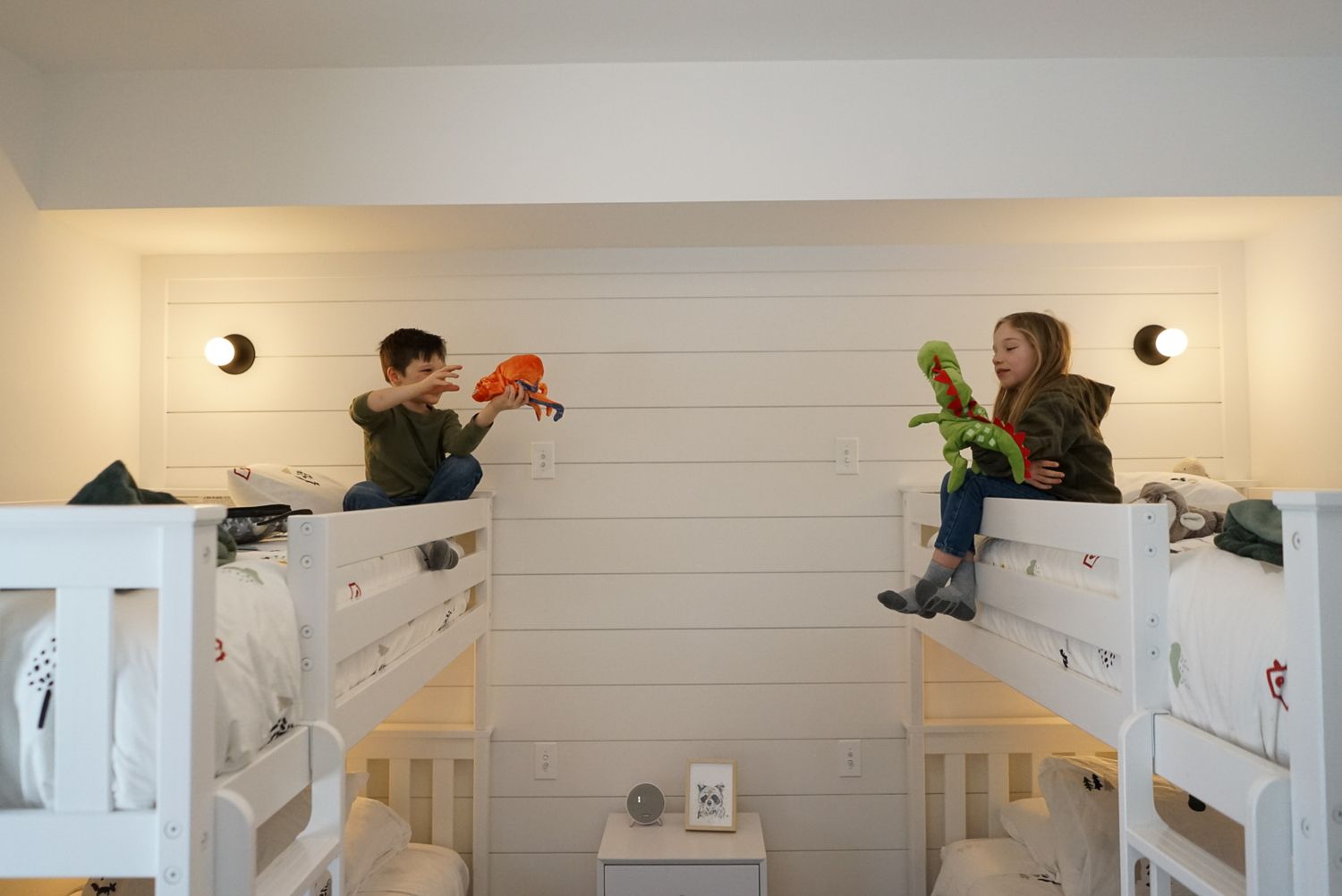 White shiplap wall with built-in shelving and decorative elements.