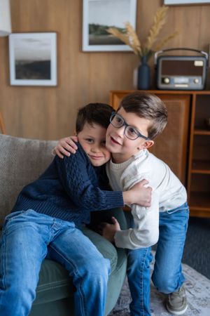 Heartwarming moment captured in modern living room with mid-century decor and wood paneling.