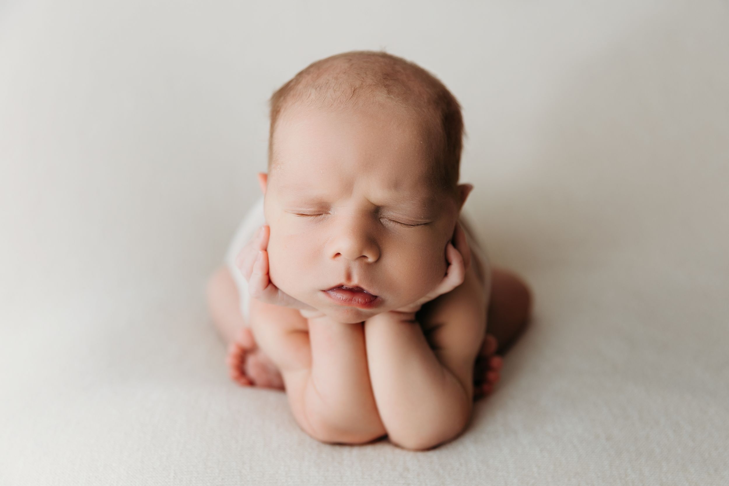 Professional newborn photography series on light background showing peaceful sleeping poses.