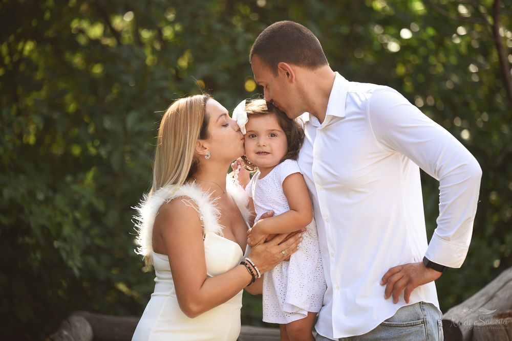 A loving family sharing a tender moment together outdoors during a golden hour photo session.