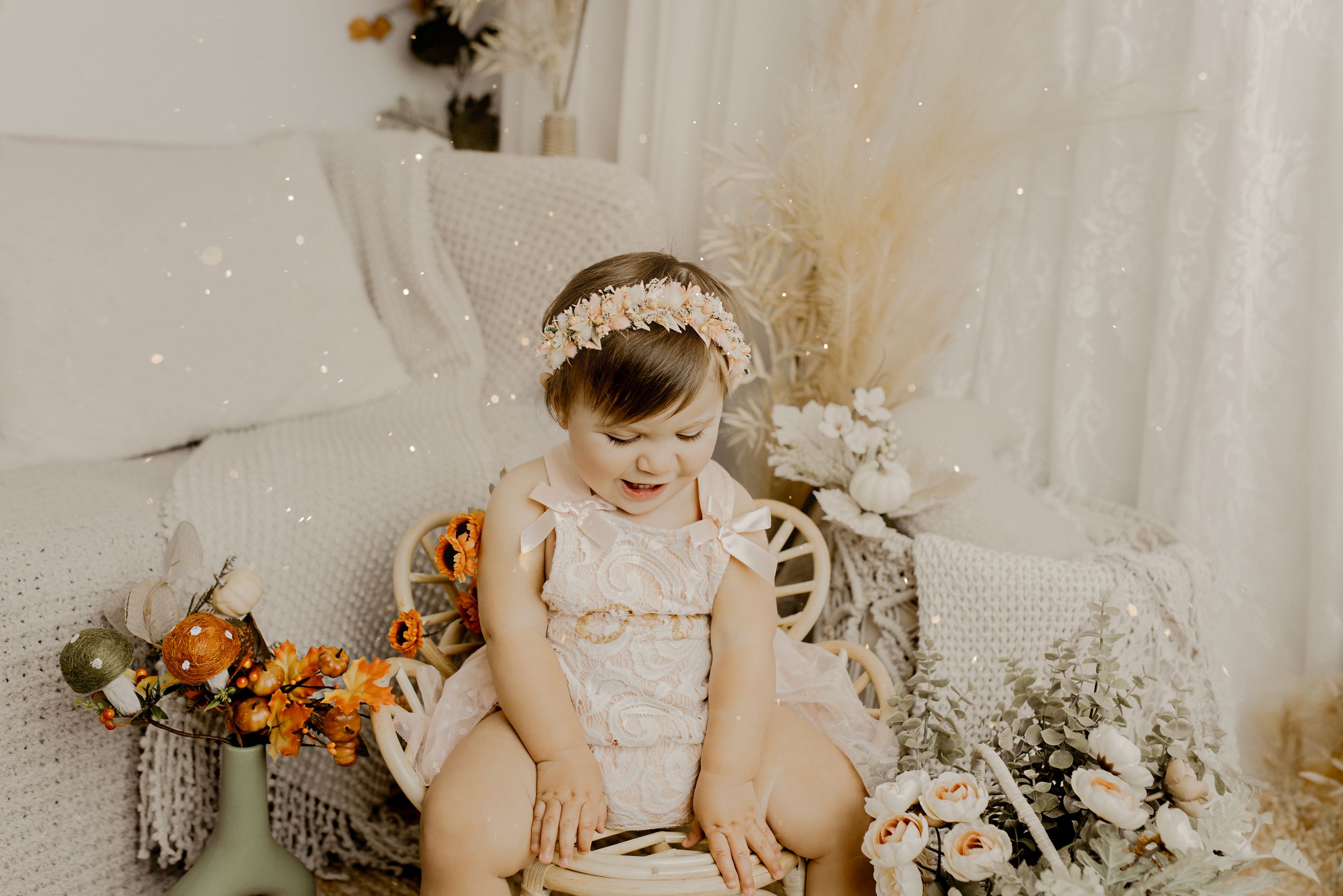 Rustic boho photography setup with dried flowers and woven textures.