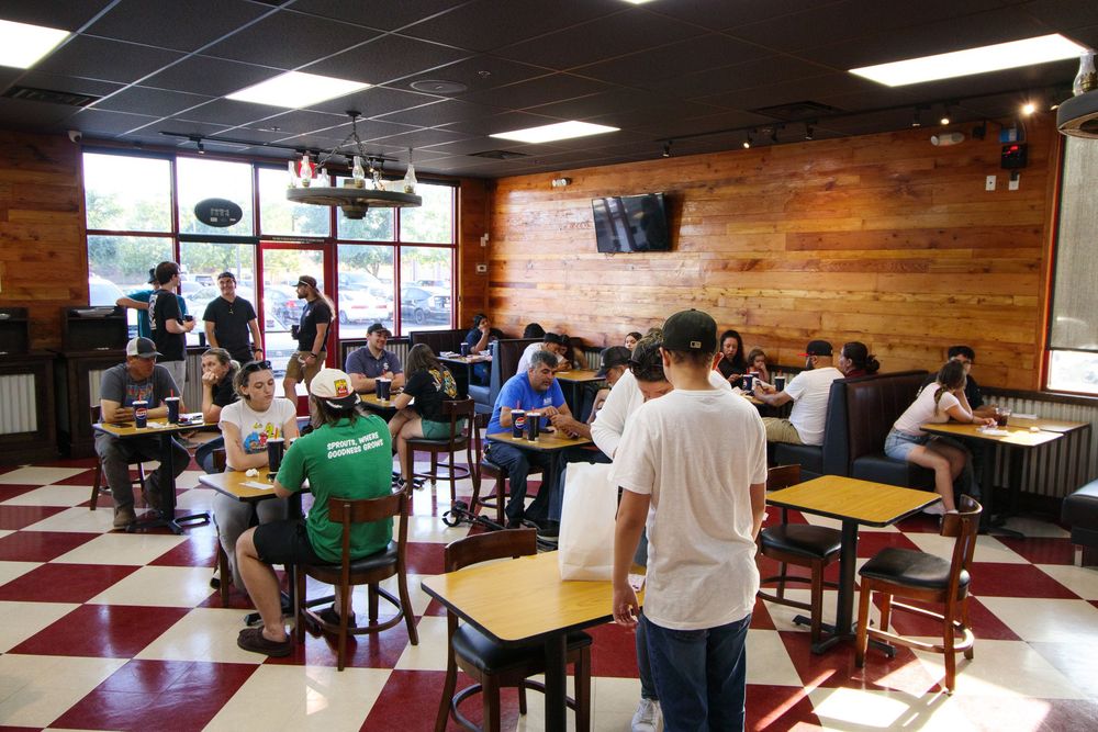 Busy Smash Bros restaurant dining room with customers enjoying meals at tables.