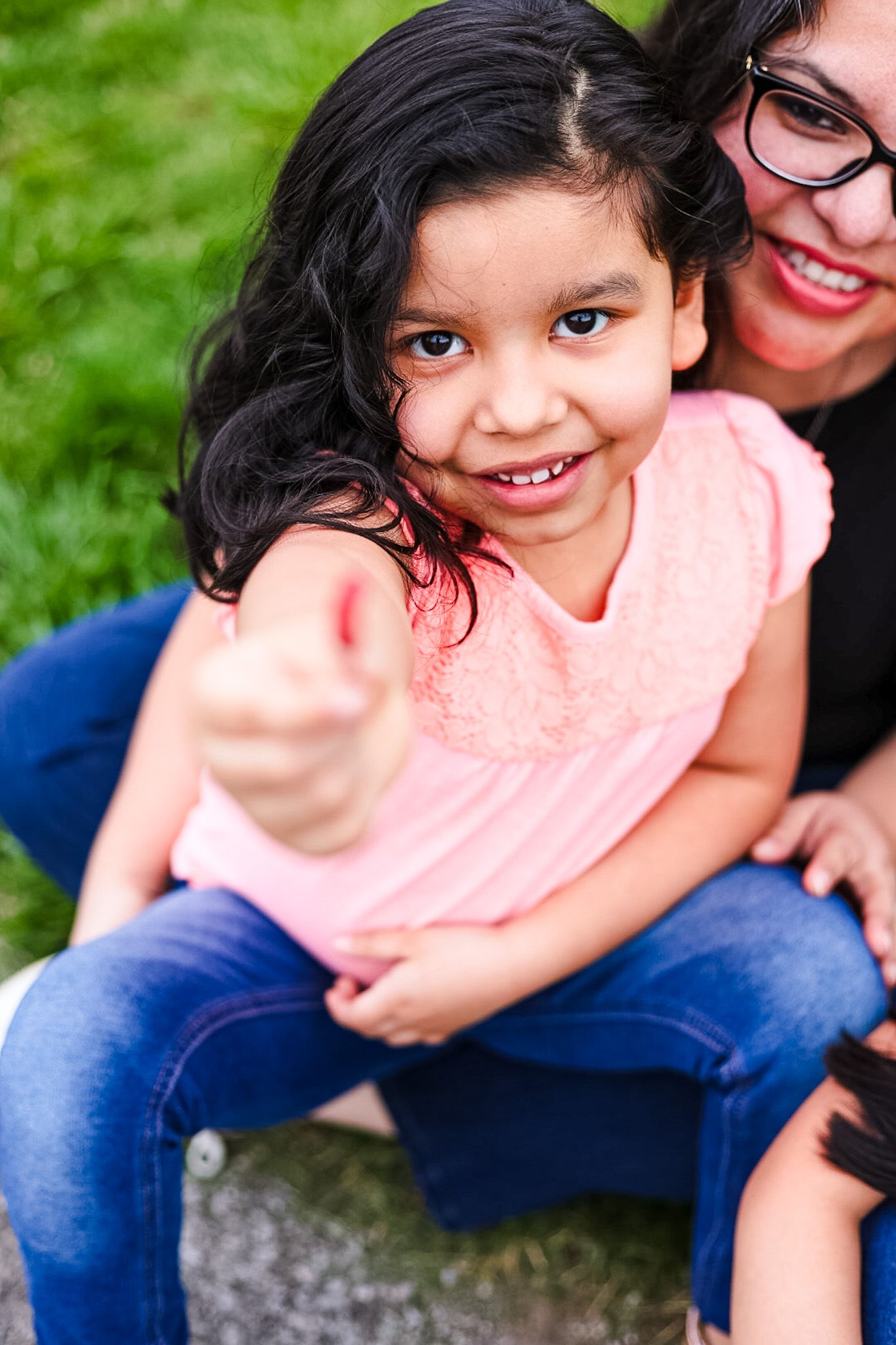 A candid lifestyle image of a mother holding her daughter smiling.