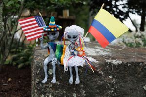 Alien figures holding Colombian and USA flags as wedding details photographed by Hudson Valley based photographer, Sasha Pierre-Louis