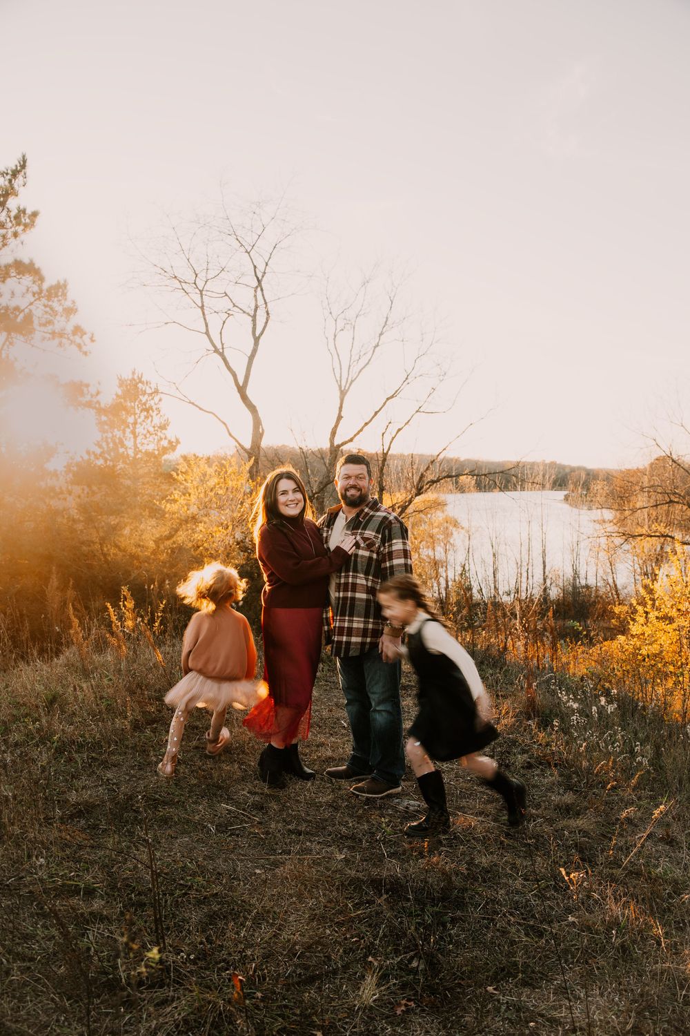Candid family photos captured on a hill during sunset showing playful interactions and natural moments.