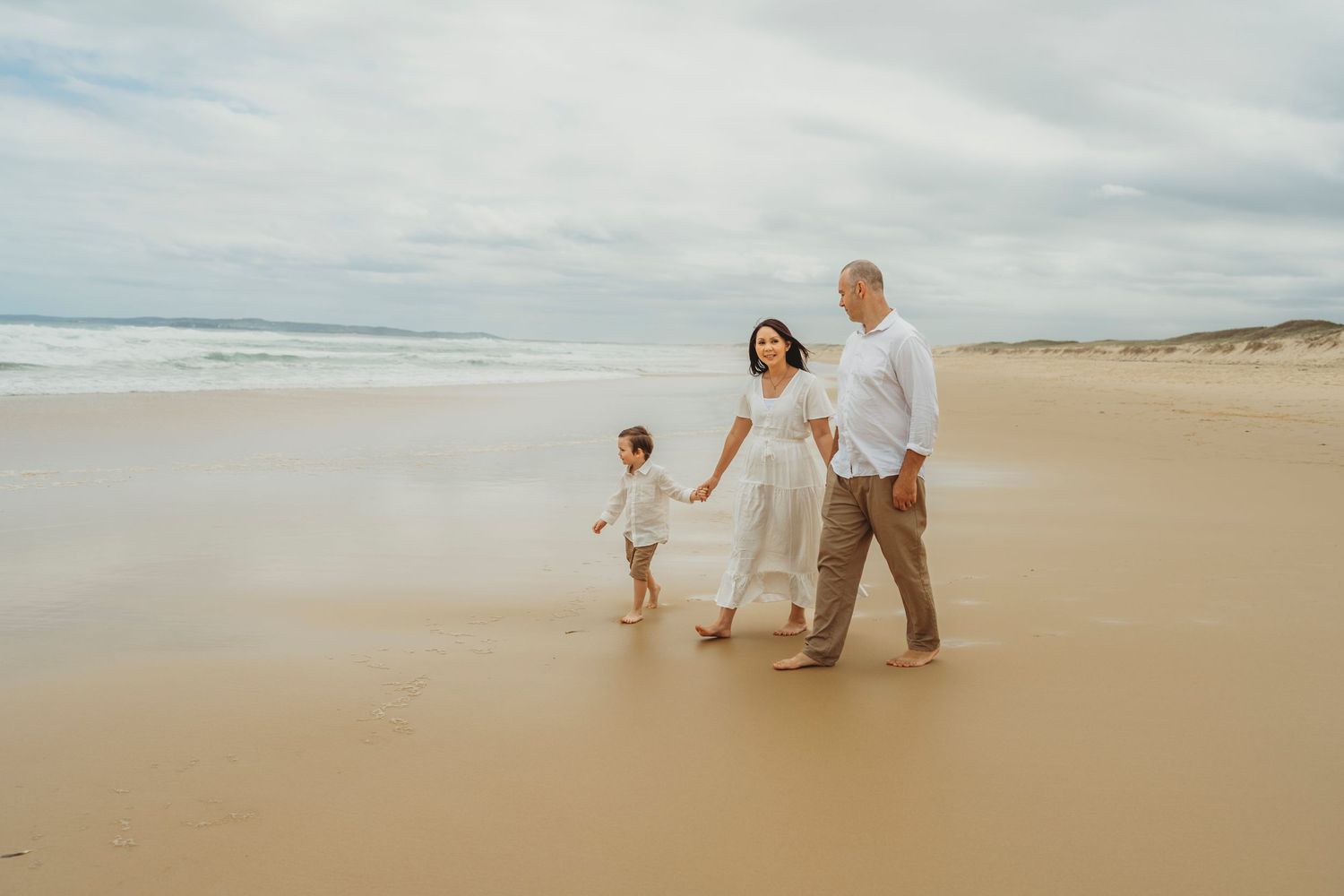 Family walking along Redhead Beach, Newcastle during family photoshoot