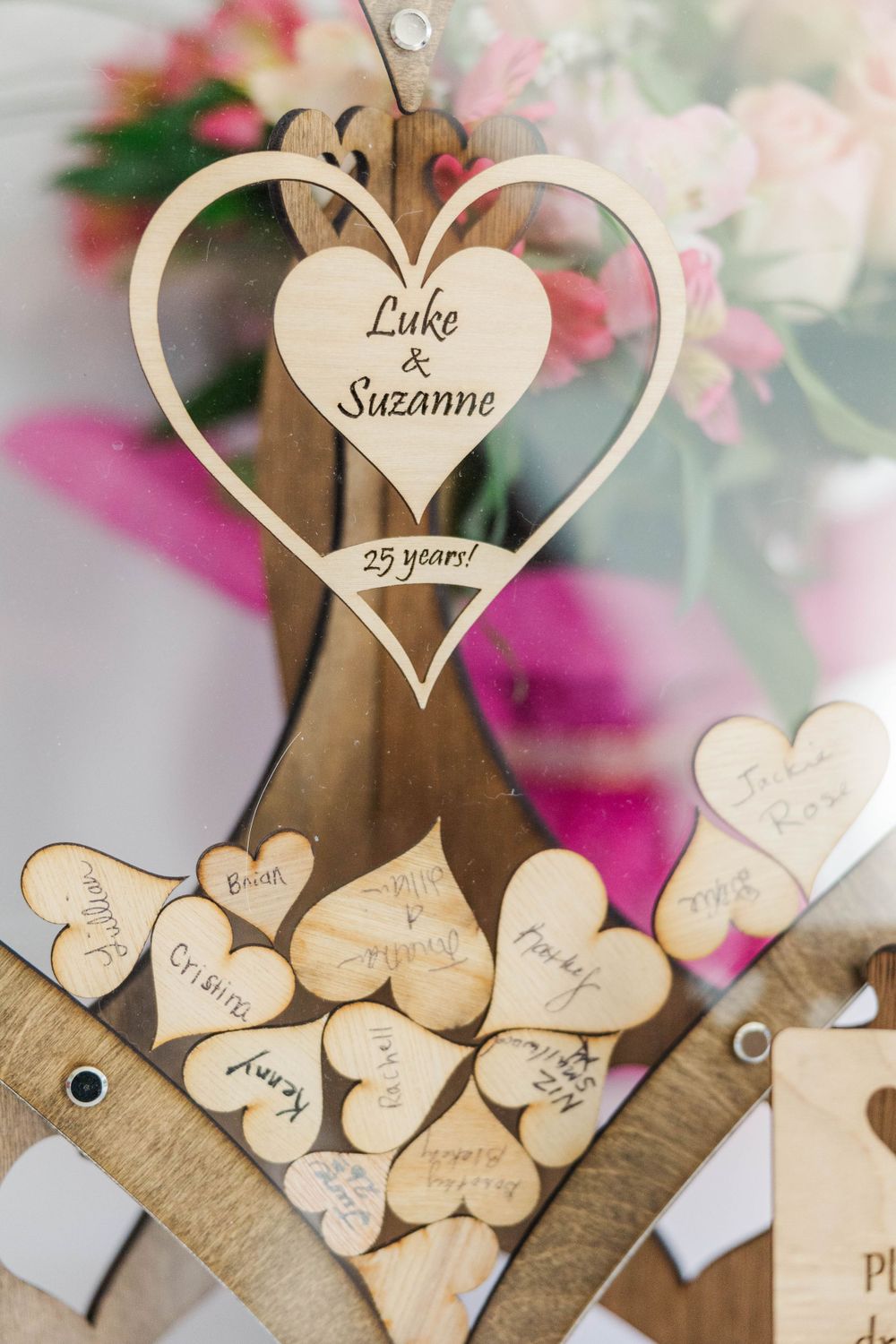 Wooden heart guest book display engraved with Luke and Suzanne 25 years with signed mini hearts.