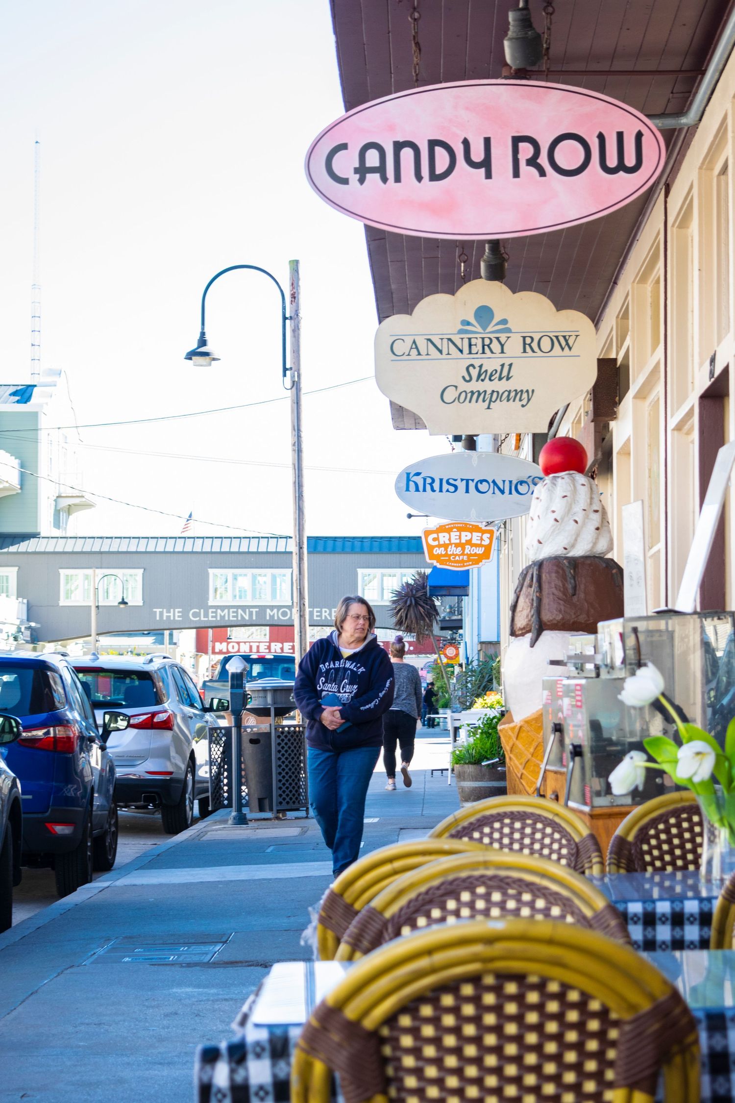 Candy Row storefront sign with outdoor cafe seating along a city sidewalk.