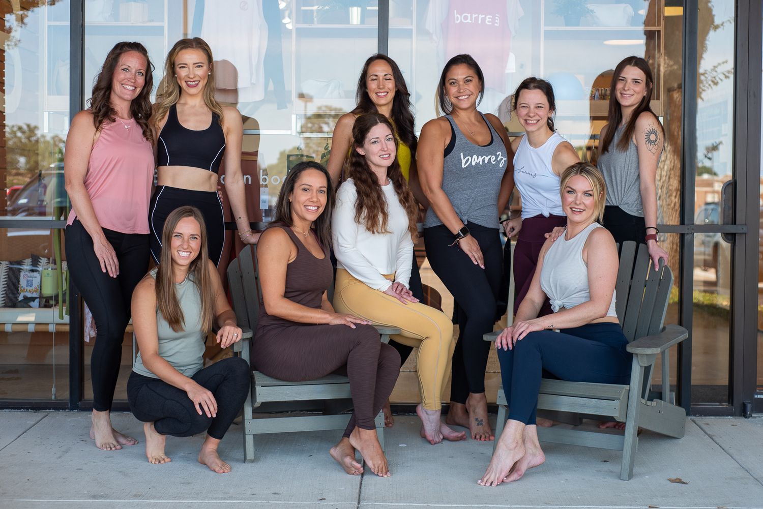 Fit women posing in front of barre3 studio.