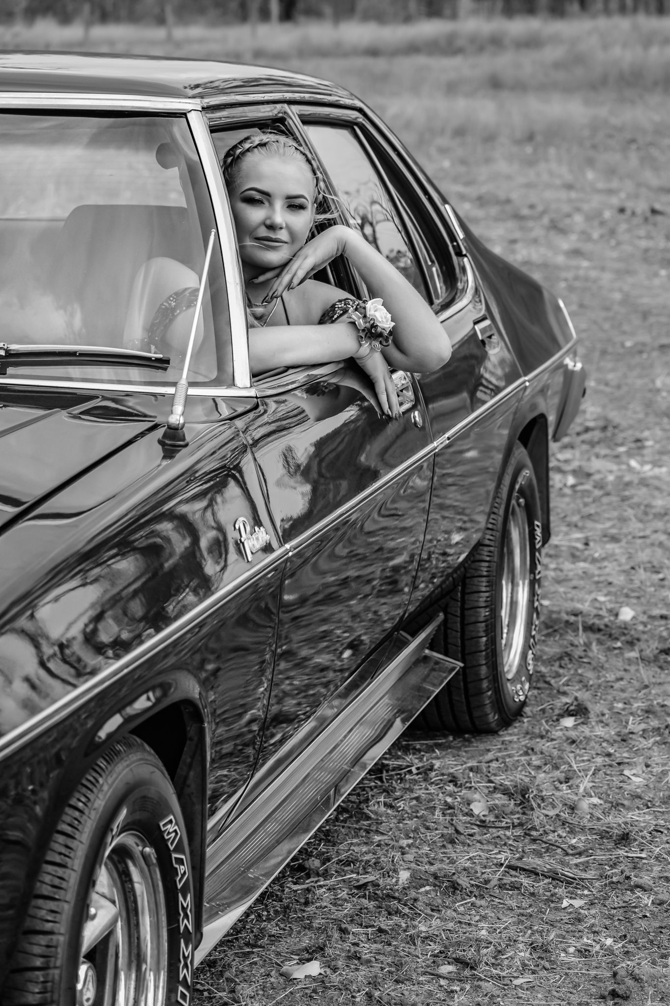 Classic vintage car portrait in black and white showing sleek automotive styling.