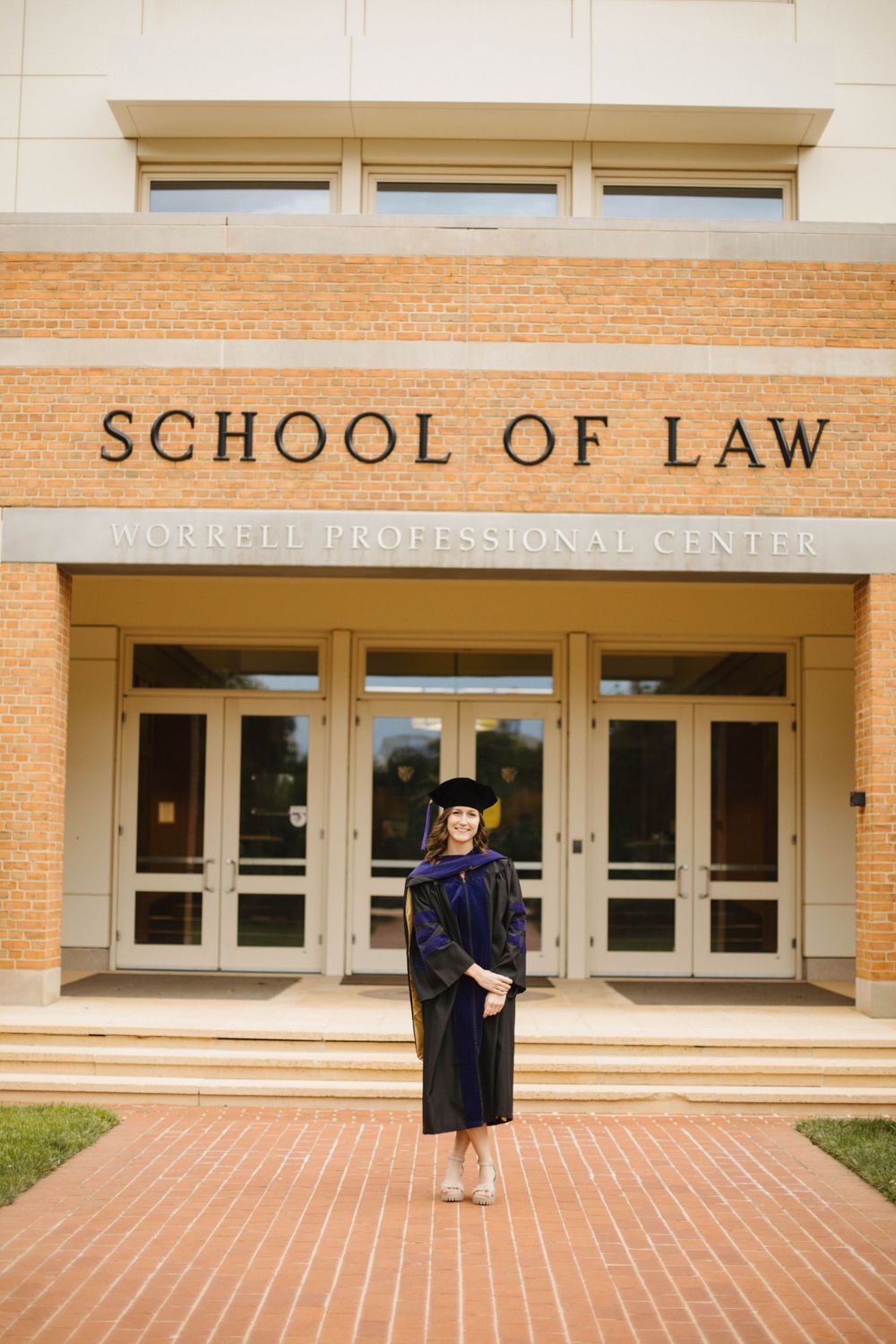 Law school building exterior with brick facade and professional center signage.
