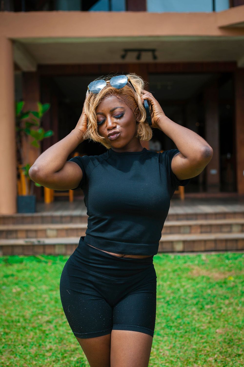Series of photos showing someone in black athletic wear posing outdoors.