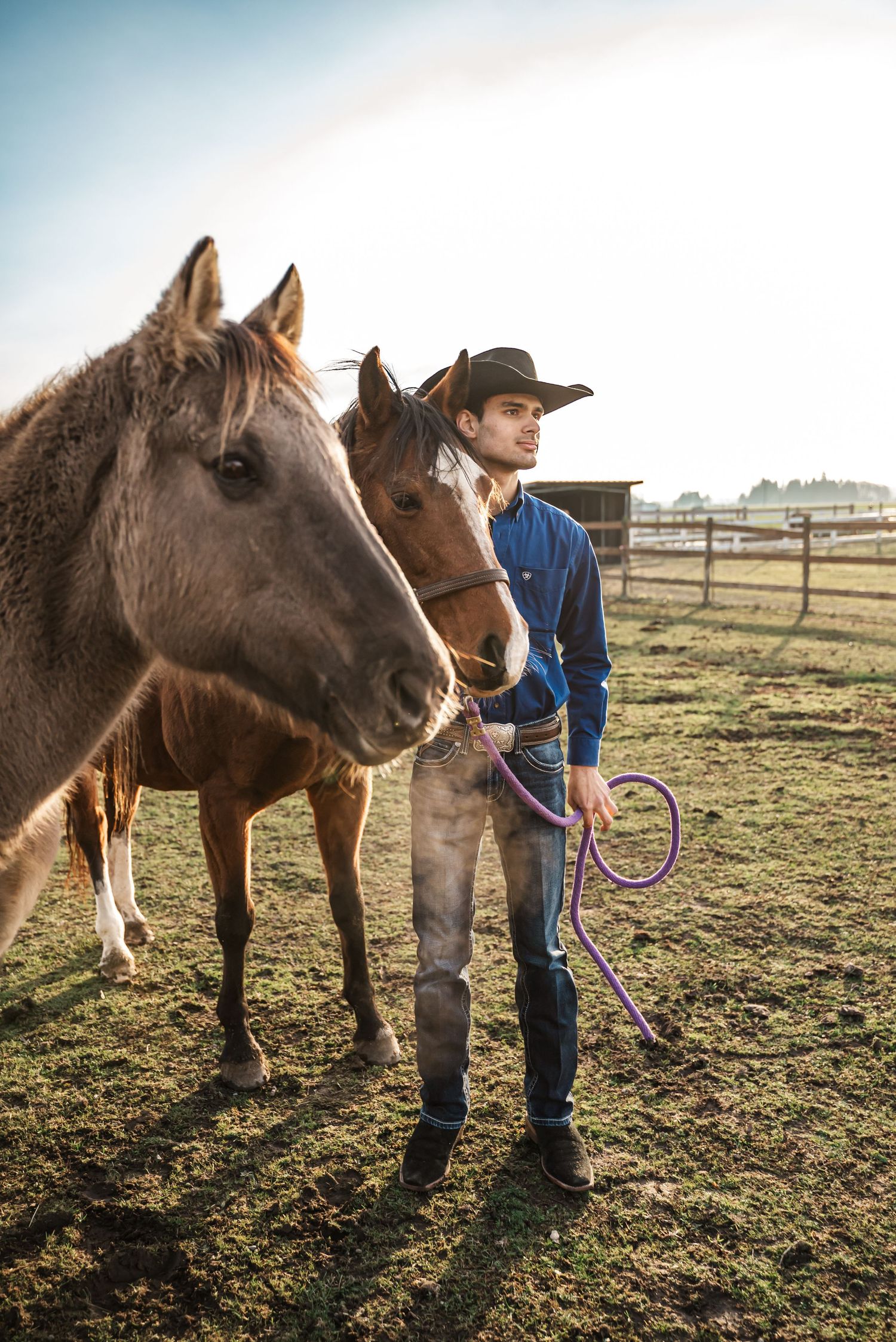 senior guy stands with his horse at a ranch in bow, washington, skagit county
