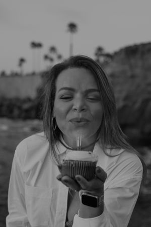 Black and white portrait series showing joyful expressions while holding a drink.