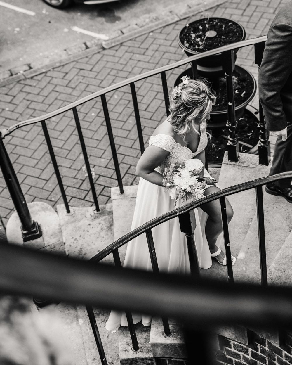 Bride walking up stairs to the Guildhall  Registry office in Poole, Dorset. Candid documentary wedding photography Poole and Bournemouth