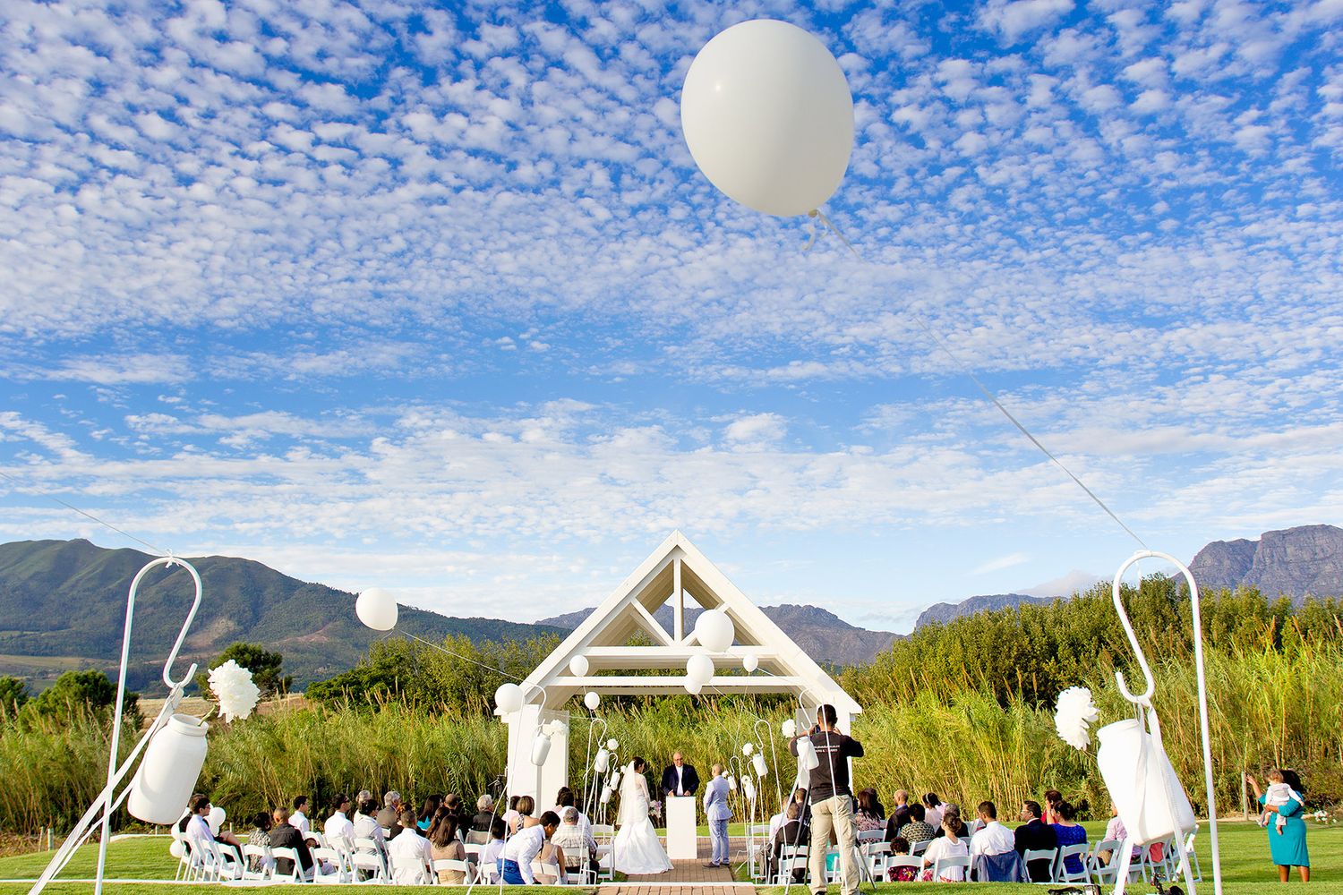outdoor wedding ceremony with beautiful clouds and mountains