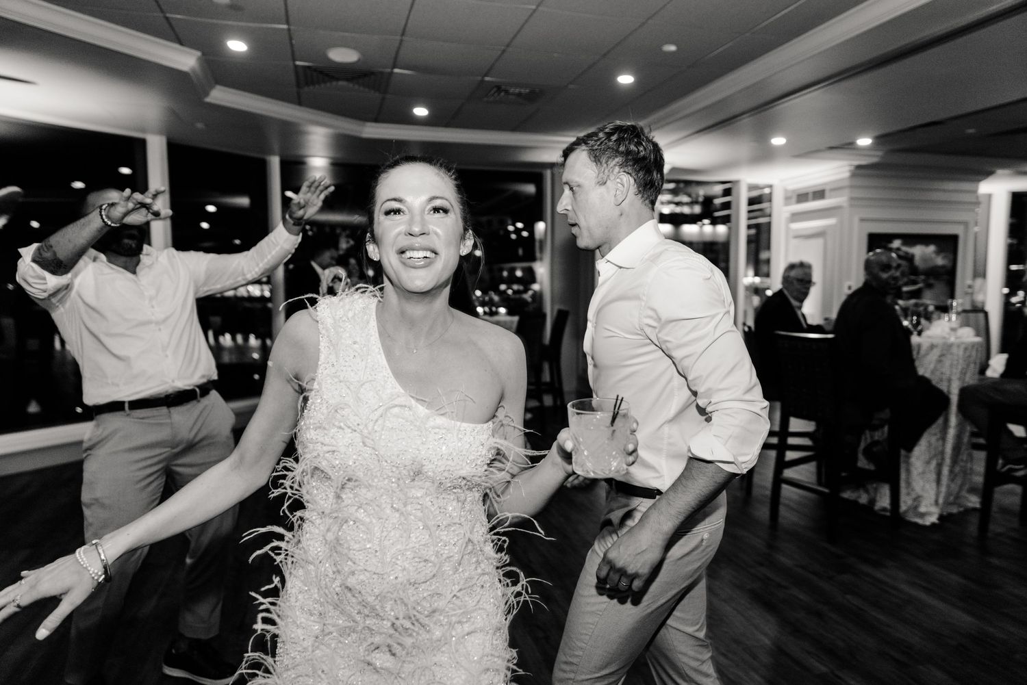 black and white photograph of bride dancing at wedding reception