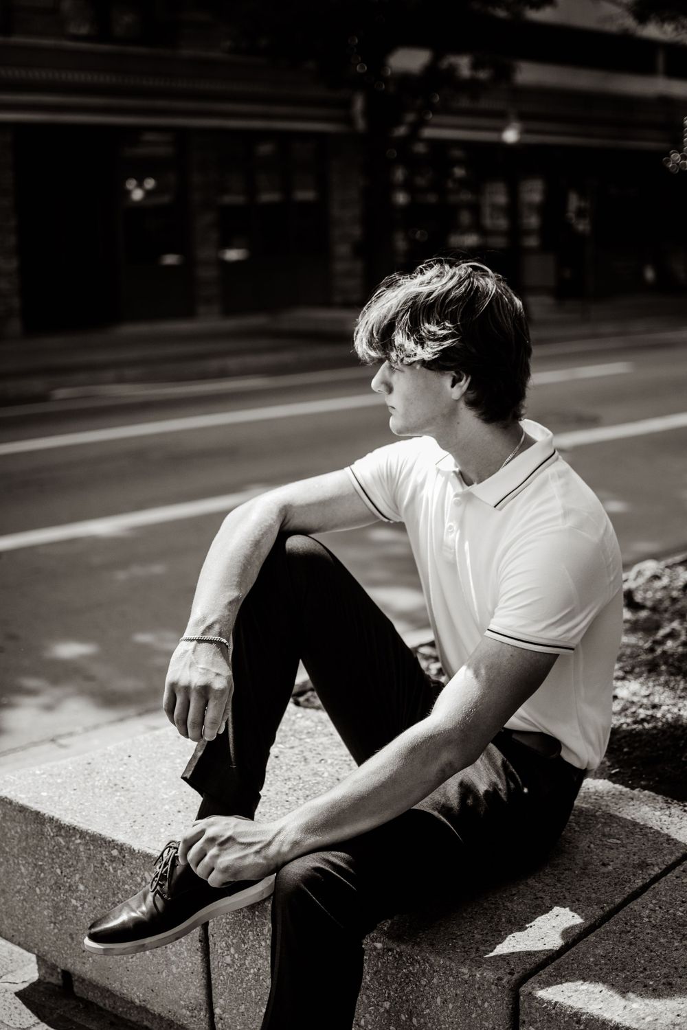Editorial senior boy photos in Downtown Fort Worth Texas. Captured among tall buildings in a black and white editing style