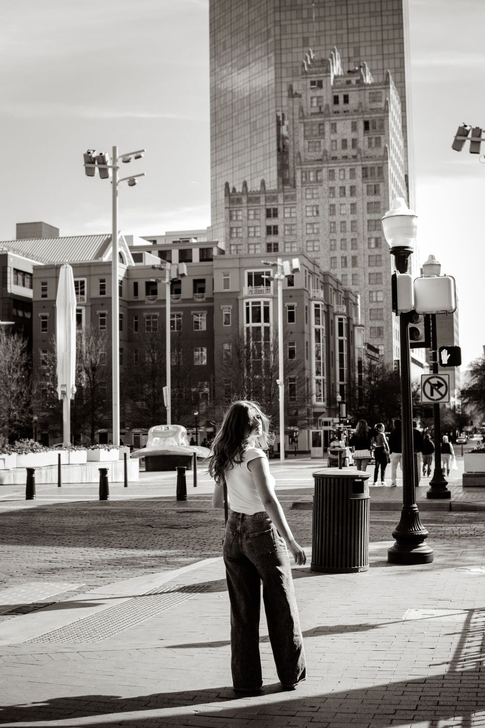 Editorial and documentary style portrait in downtown Fort Worth, Texas in front of the iconic silver cowboy hat sculpture in Sundance Square