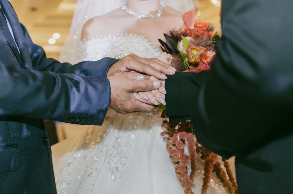 Wedding reception toast moment with champagne glasses in an elegant ballroom setting.