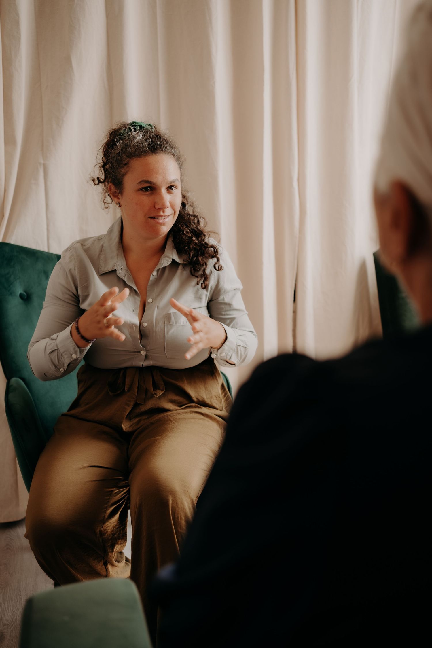 Wellness consultation taking place in a cozy office setting with white curtains.
