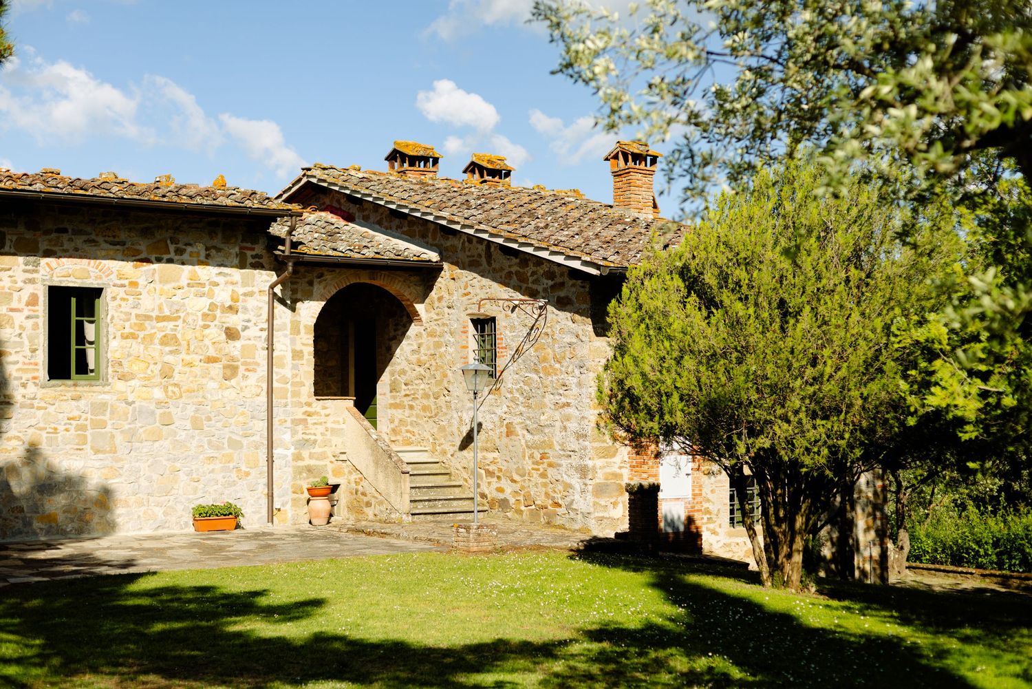 Rustic Italian villa exterior with stone walls and traditional Tuscan architecture.